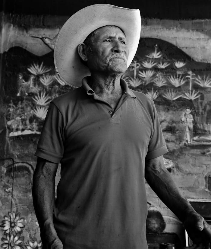 heros-img Black and white portrait of an elderly Oaxacan cowboy with a sombrero, reflecting traditional Mexican culture.
