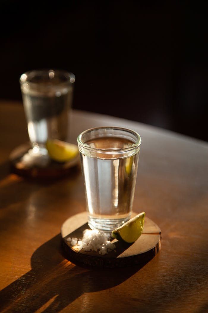 our-story Close-up of tequila shot with lime and salt, perfect for beverage themes.